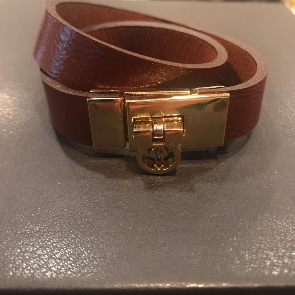 Leather wrap bracelet with gold tone hardware.